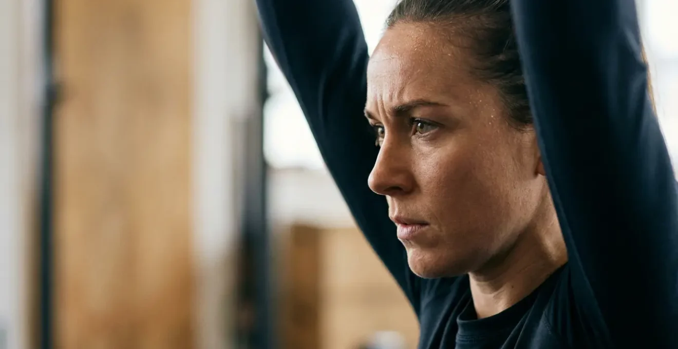 Athletic trainer demonstrating proper overhead squat assessment technique in clinical setting