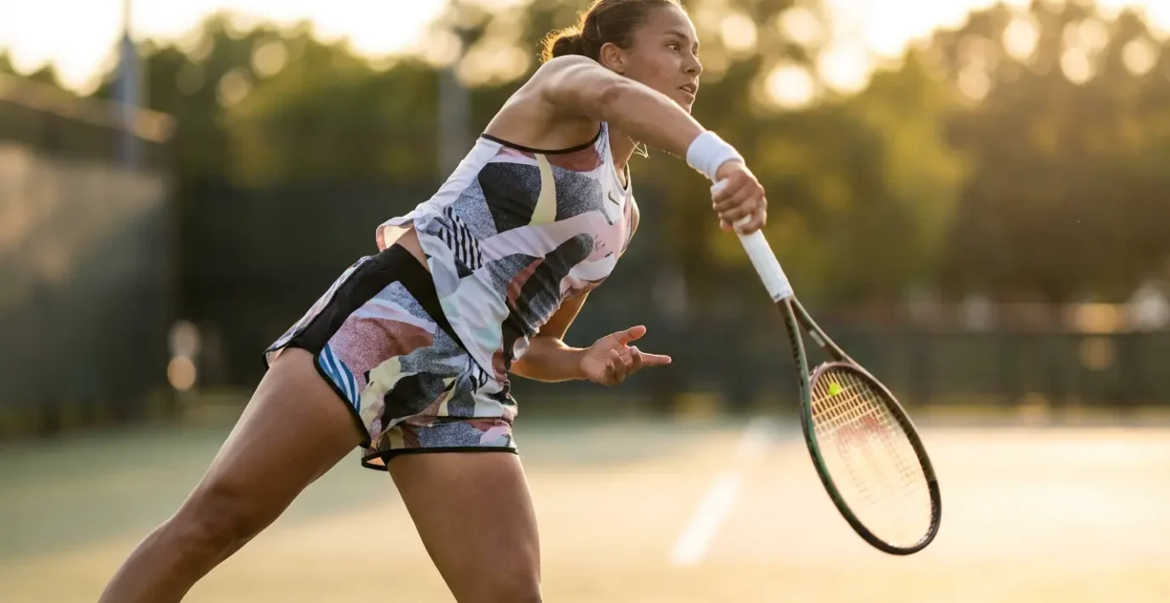 Tennis player at peak serve motion showcasing racket dynamics and energy transfer